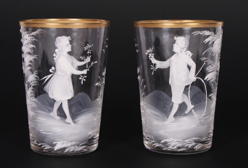 A pair of 19th Century ""Mary Gregory"" beakers with boy and girl decoration and gilt rims, 4 1/4""