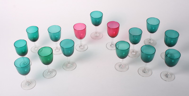 Thirteen wine glasses with green glass bowls, various, and two similar wine glasses with ruby glass