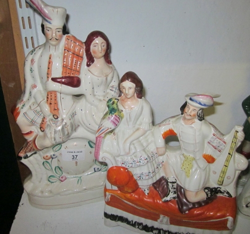 A 19th Century Staffordshire flatback group, two figures with parrot and music on a chaise longue,