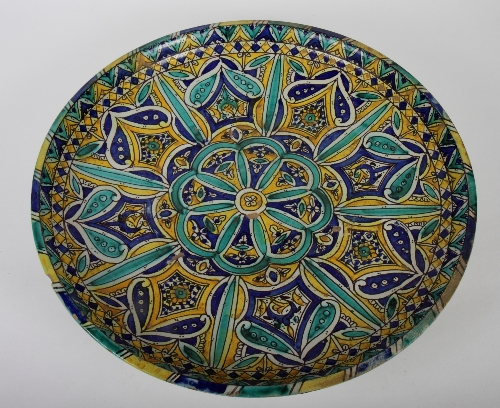 A Hispano Moresque charger with green, blue and yellow geometric decoration, 18" dia