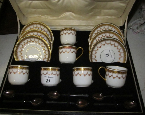 A Limoges gilt decorated coffee set with six silver coffee spoons, in case