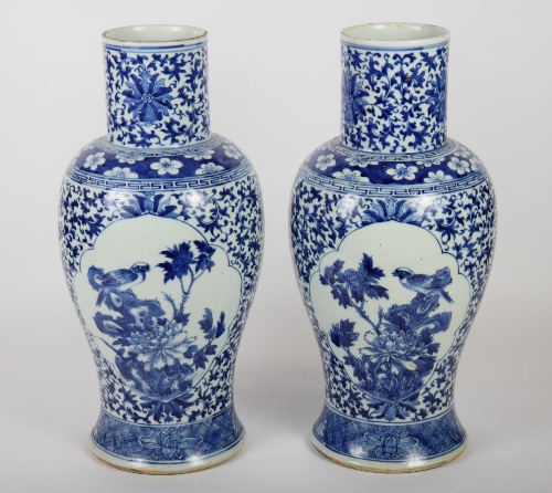 A pair of Chinese porcelain vases decorated panels of birds and foliage, 18" high (repaired)