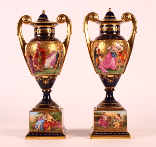 A pair of 19th Century Vienna porcelain oviform vases painted classical scenes with gilt handles and