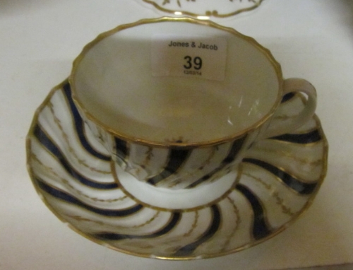 An early 19th Century Worcester spiral fluted blue and gilt decorated tea cup and saucer