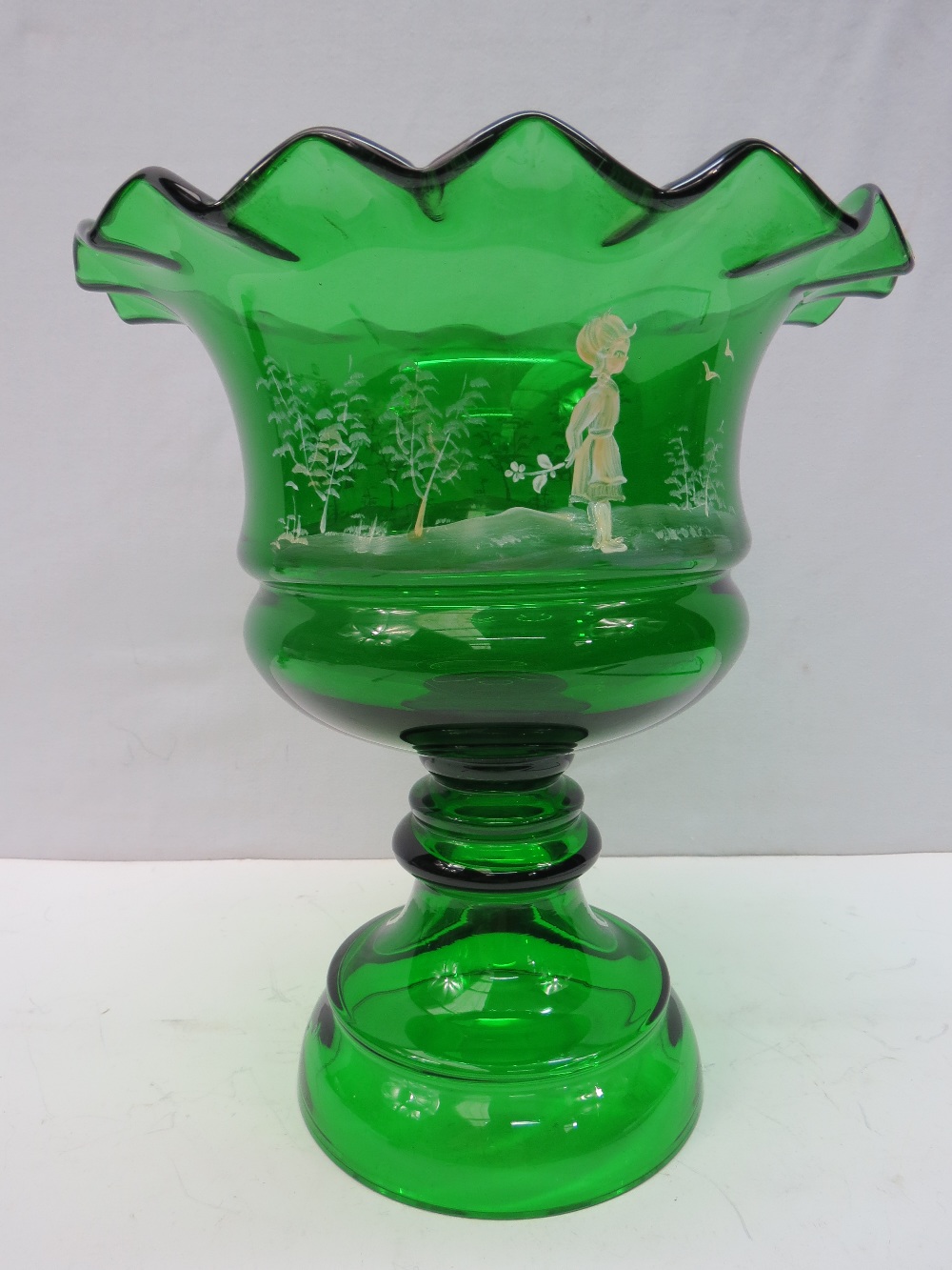 A large Mary Gregory style green glass pedestal bowl with overlay decoration, 25cm