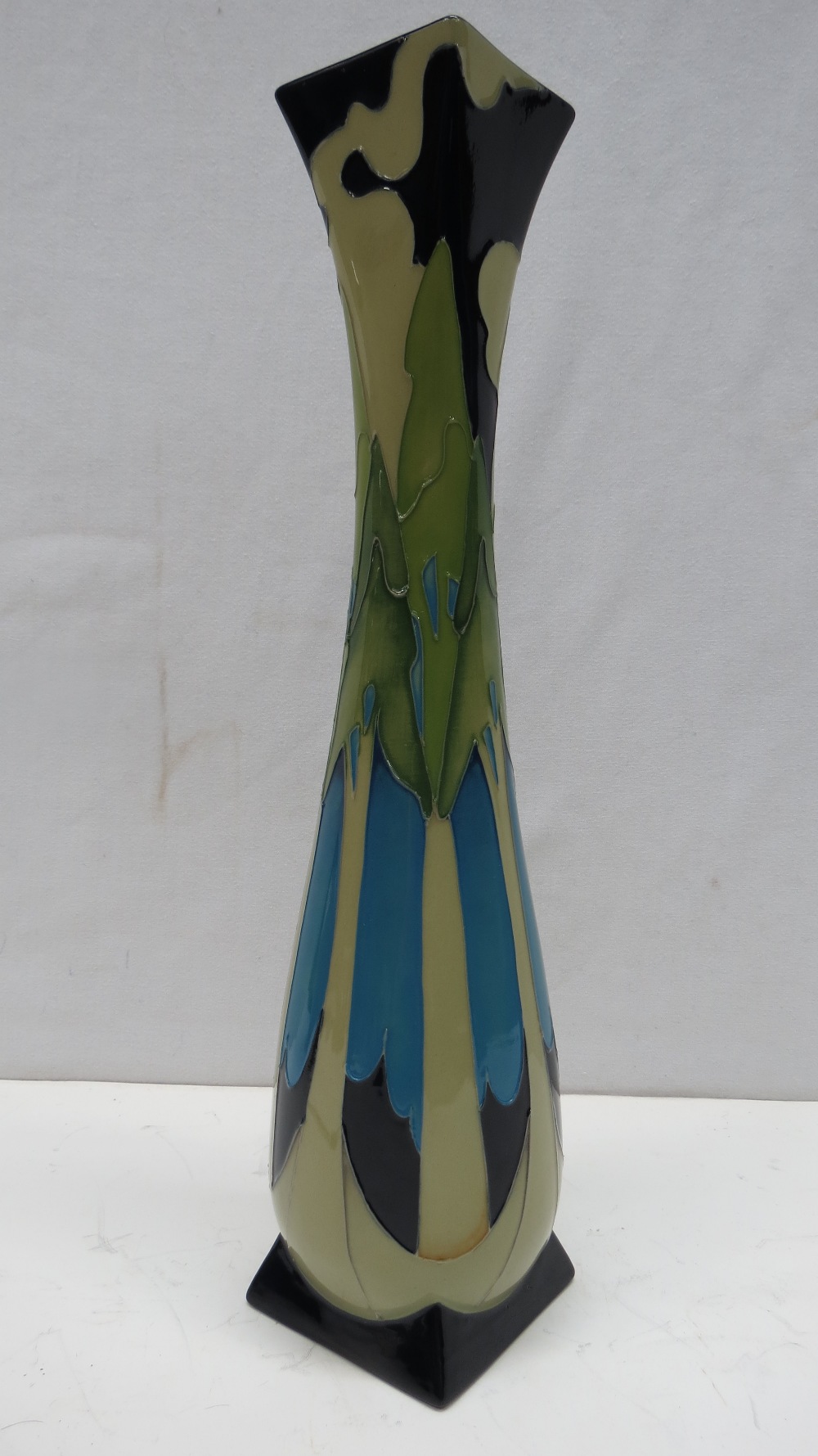A Moorcroft tall vase with moonlit firs design, 35cm high.
