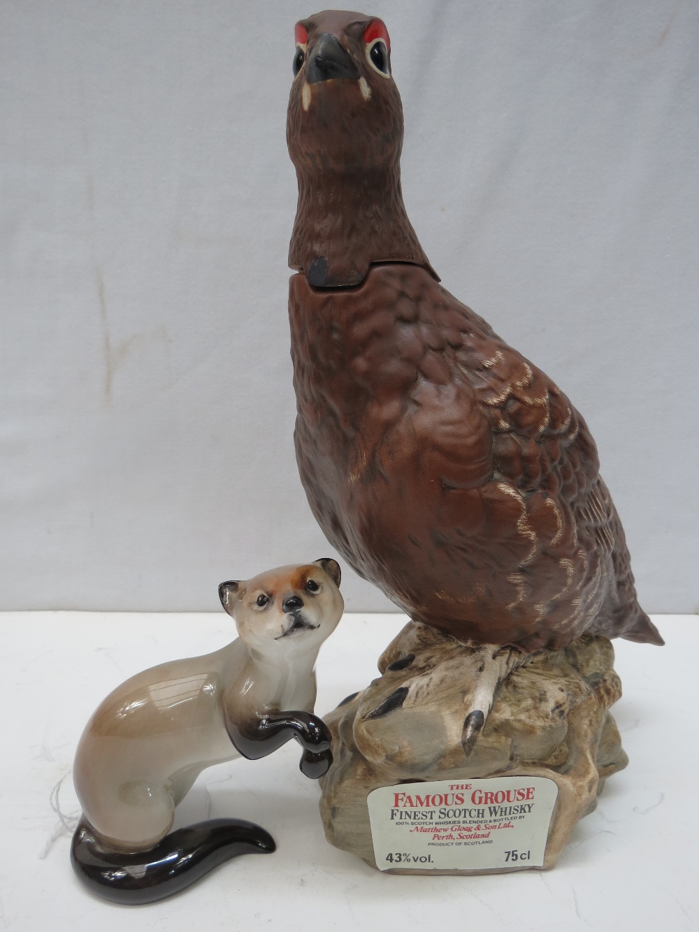 A Doulton figure of a pine marten, model HN2656, 11cm, together with a Doulton Famous Grouse