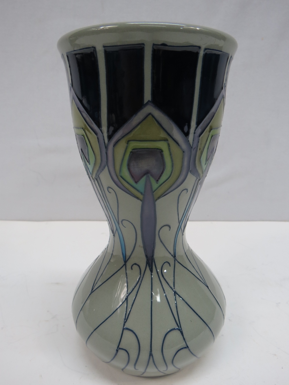 A Moorcroft waisted vase with peacock feather design, stamped '2012'; 18cm.