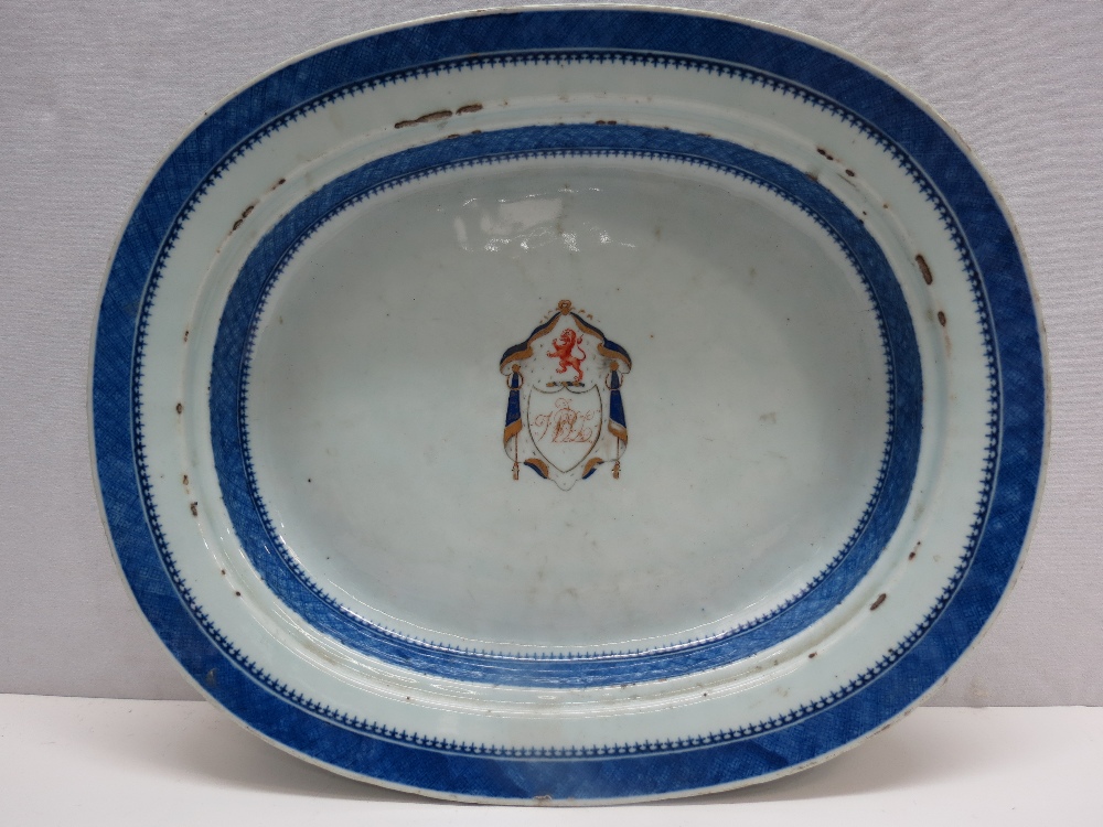 An 18thC Chinese oval blue and white export porcelain dish with central armorial crest with a lion