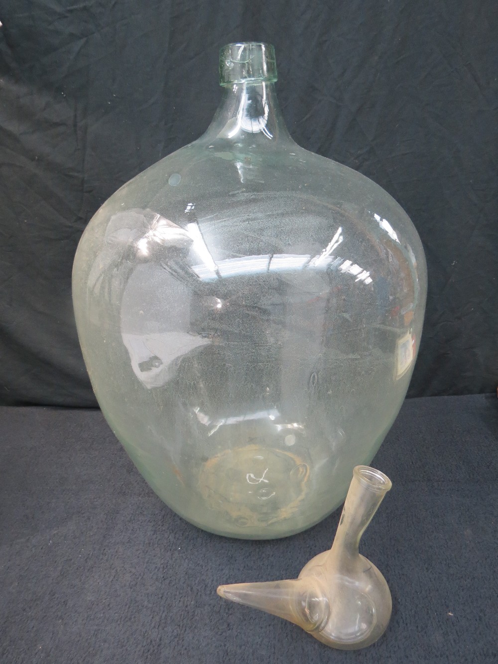 A very large clear glass jar, 63m high, diameter 40cm approximately also a Spanish wine dispenser.