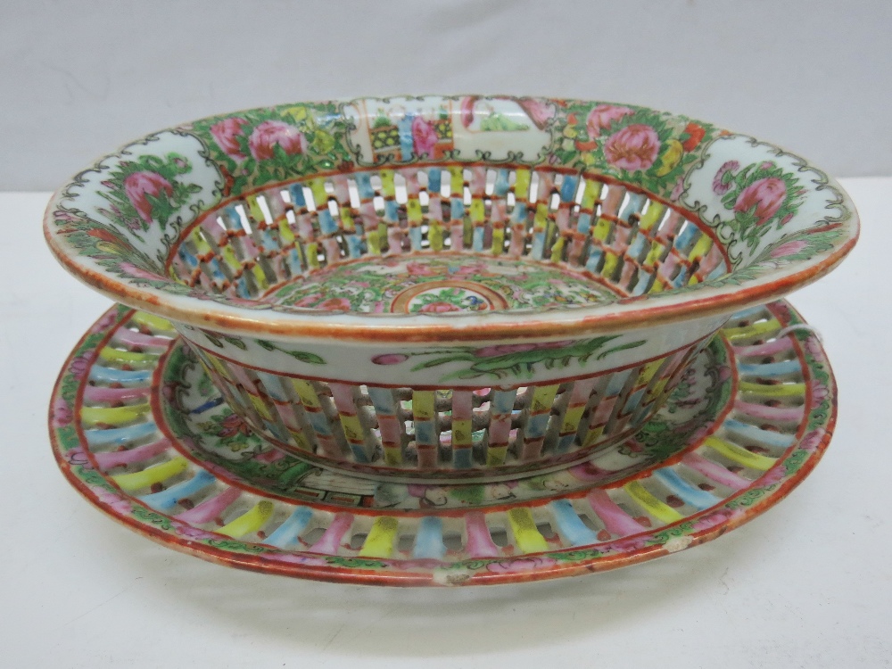 A reproduction Chinese Famille Rose pierced oval bowl and stand, diameter 23cm oval, having `Made