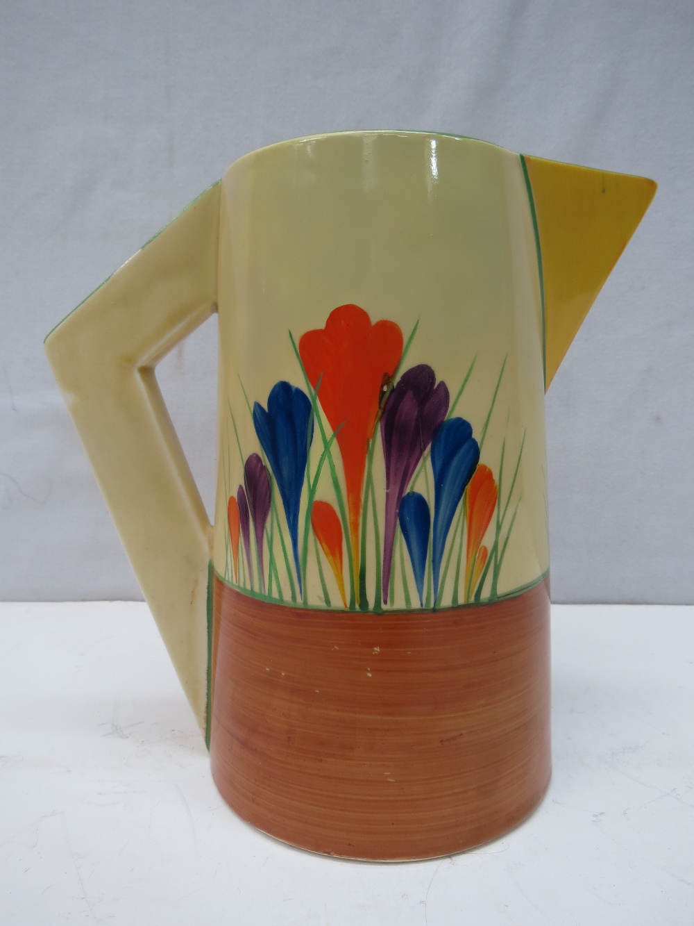 A Clarice Cliff Art Deco jug with Autumn Crocus design c.1930`s, 18cm.