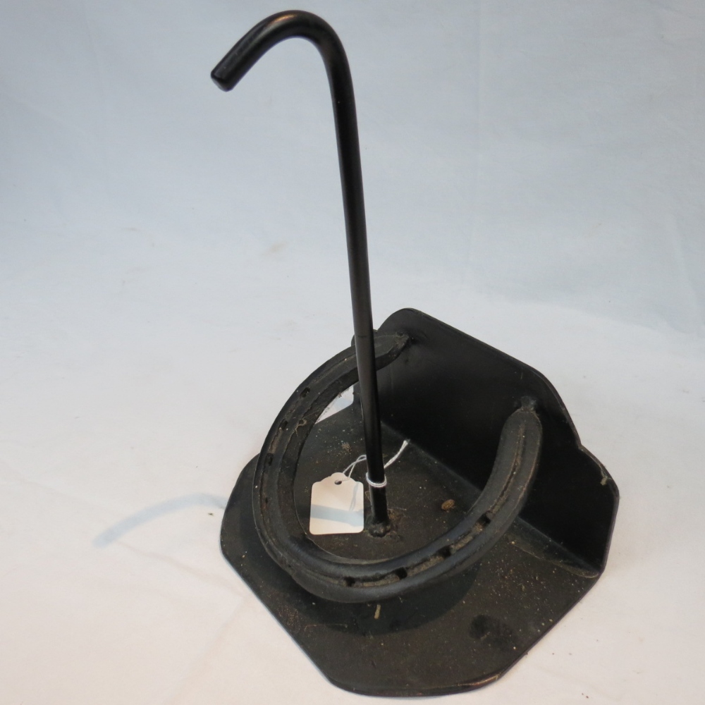 A blacksmith made iron doorstop incorporating a horseshoe, black finish, approx 25cm high.