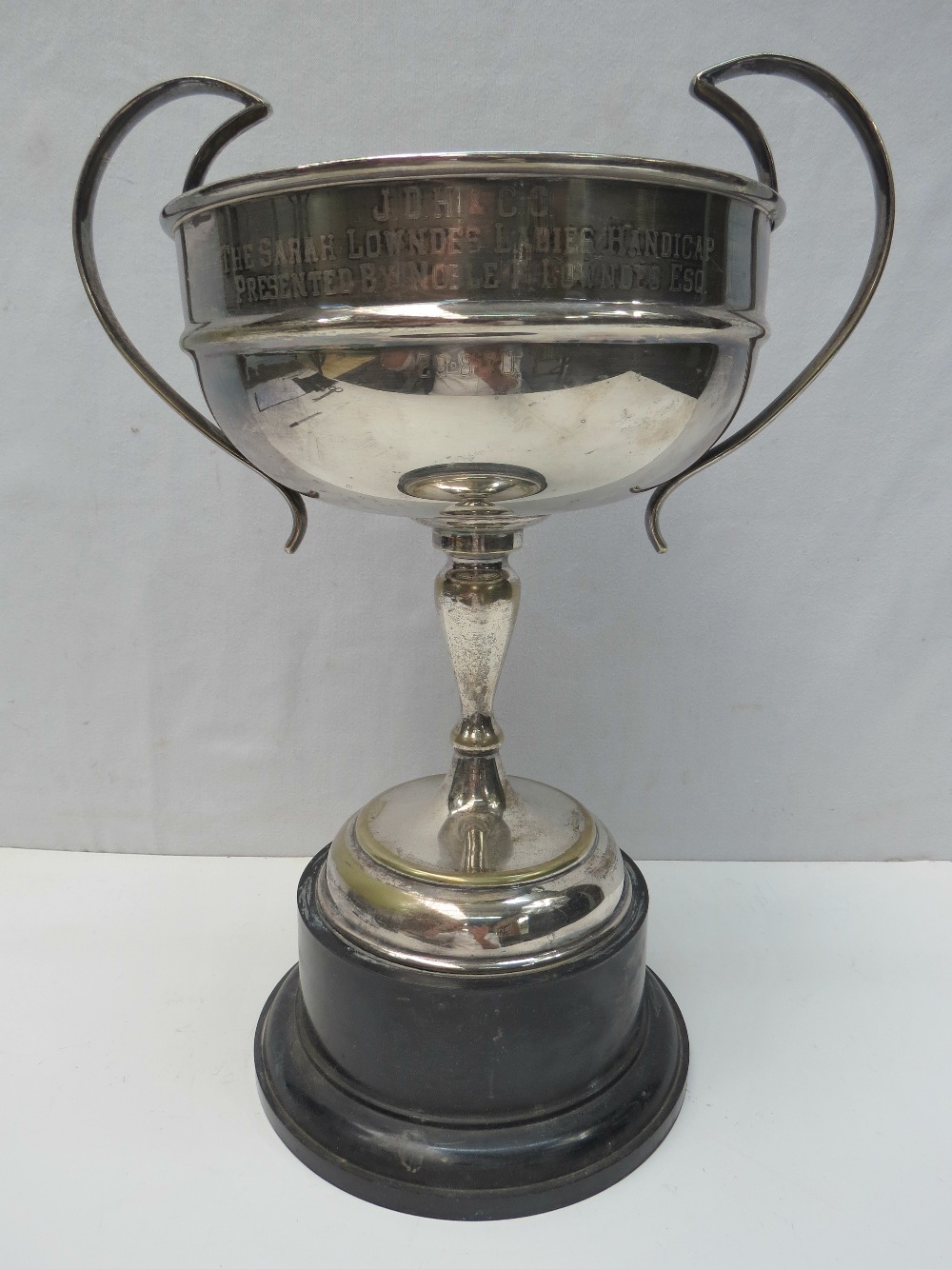 A twin handled trophy cup in silver plate being a prize for the Sarah Lowndes Ladies Handicap, on