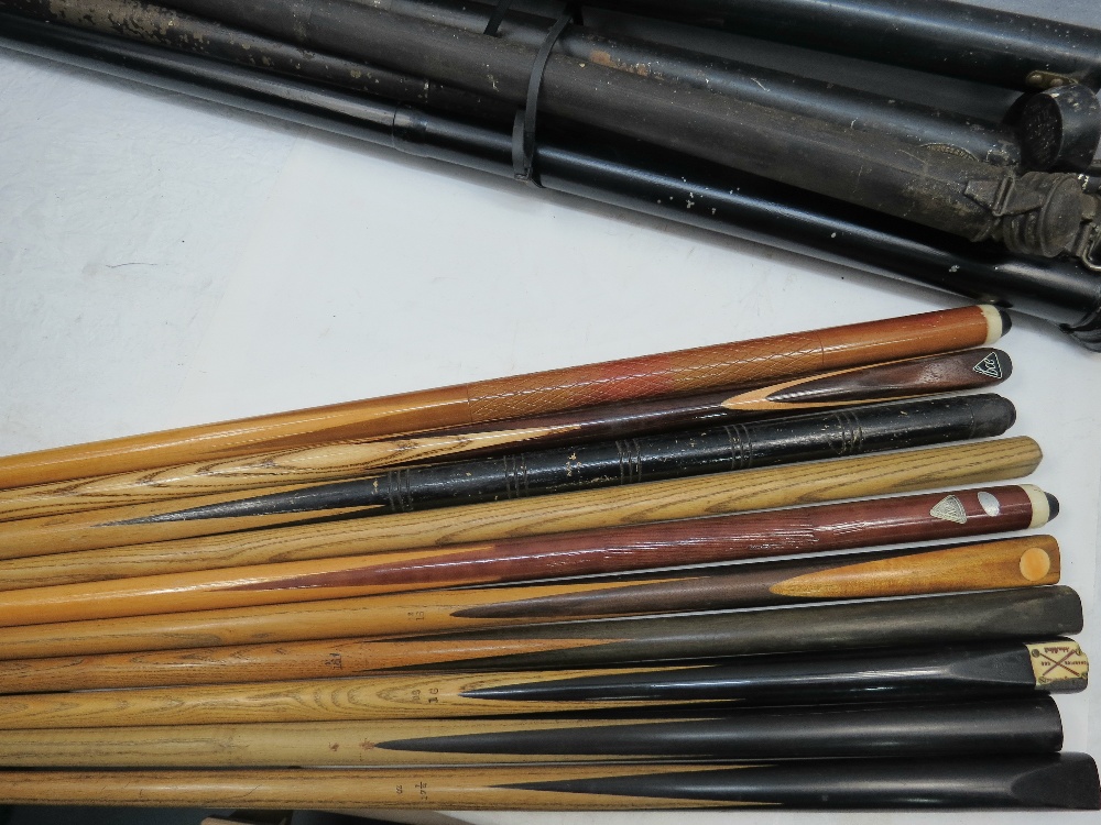 A collection of ten vintage snooker cues with four in metal cases.