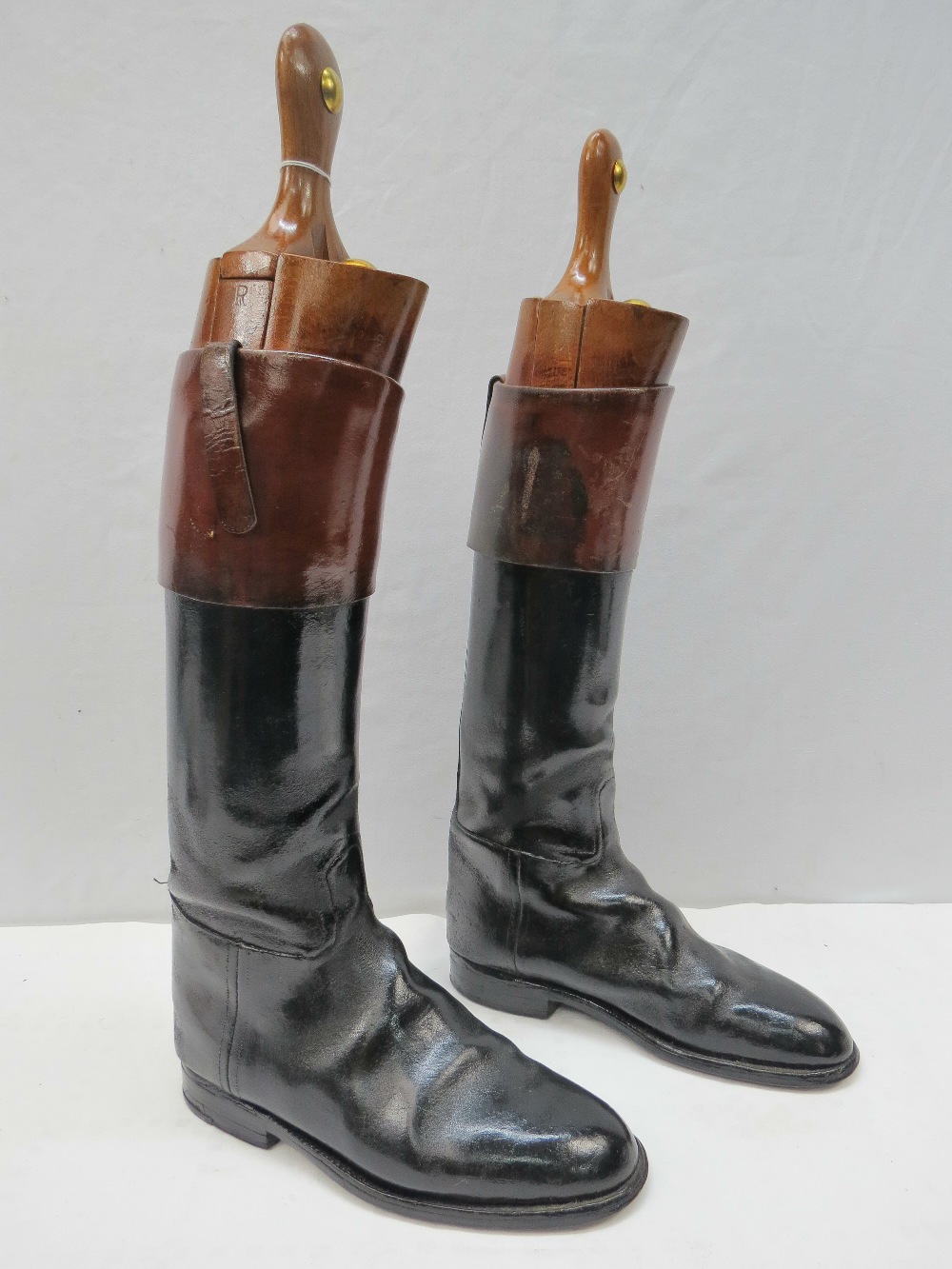 A pair of black and tan top boots with beechwood trees by Horace Batten of Ravensthorpe, Northants.