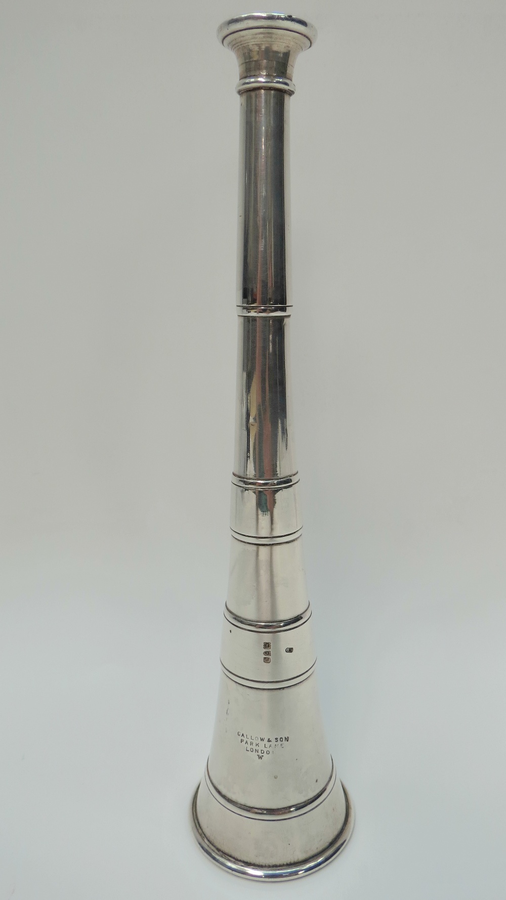 A cast silver hunting horn bearing the London hallmark for 1897-8 with maker's stamp LD. With