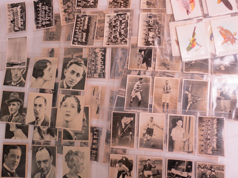 Cigarette card medium size selection of sporting events, cinema, birds. 34 cards in total.