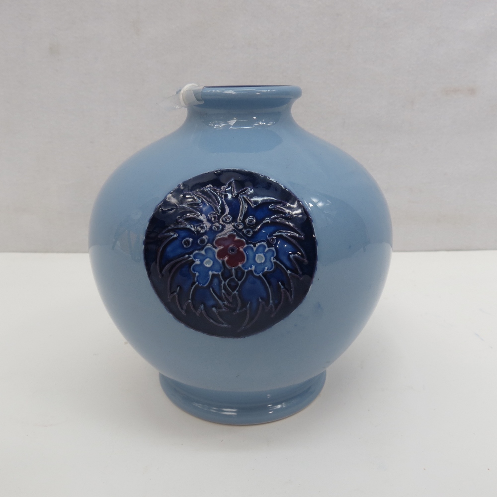 A Moorcroft blue trial vase with floral motifs, height 13cm