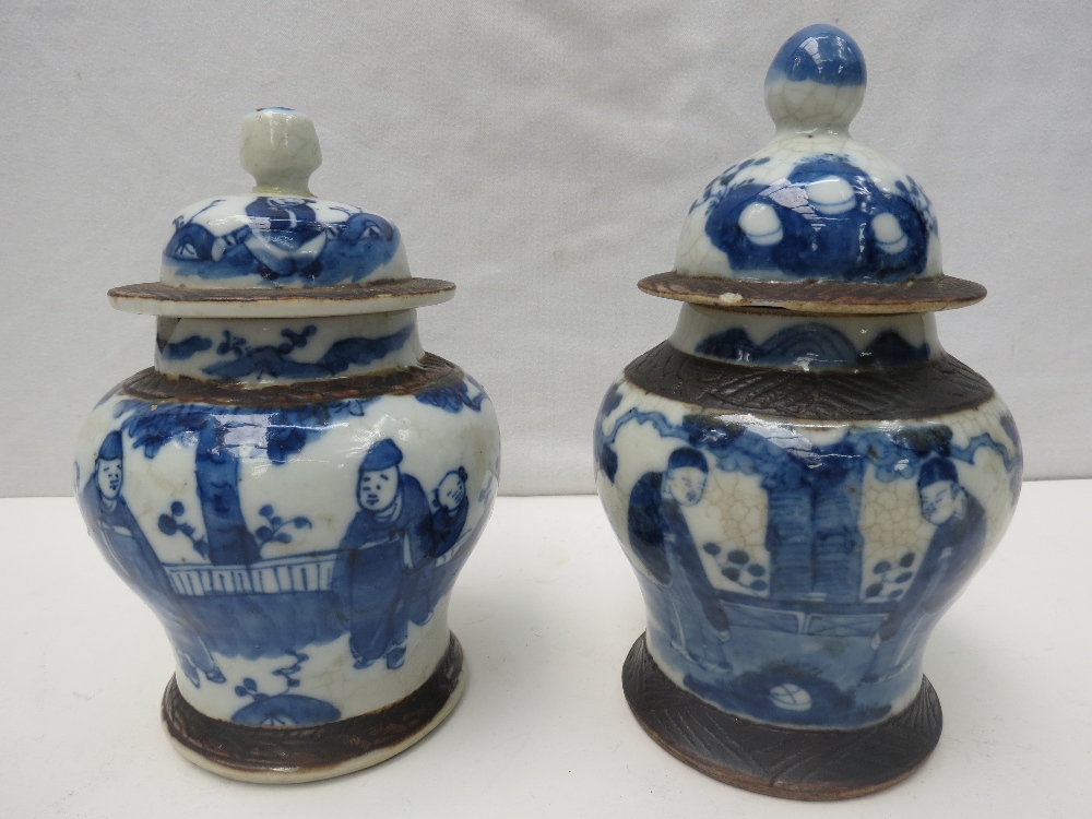 A pair of 19thC blue and white Oriental export ginger jars with covers. One finial AF.