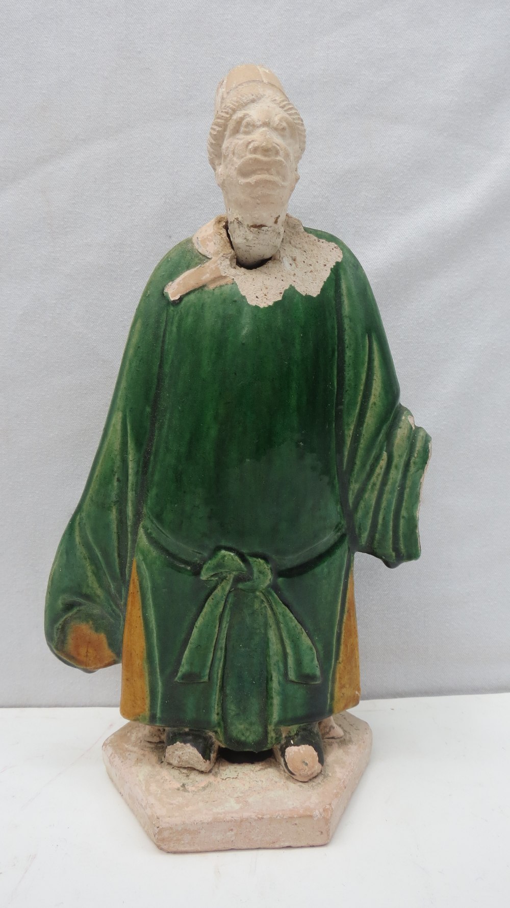 Chinese  funeral figure, said to be 16thC and having a green gown over a yellow ochre long shirt,