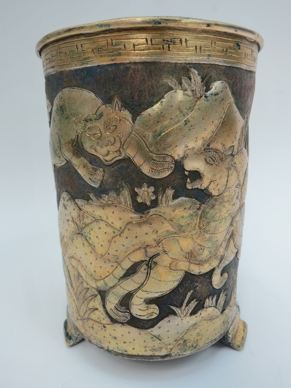 A Japanese fine metal brushpot, repousse work, depicting tigers in a plum blossom landscape, upper