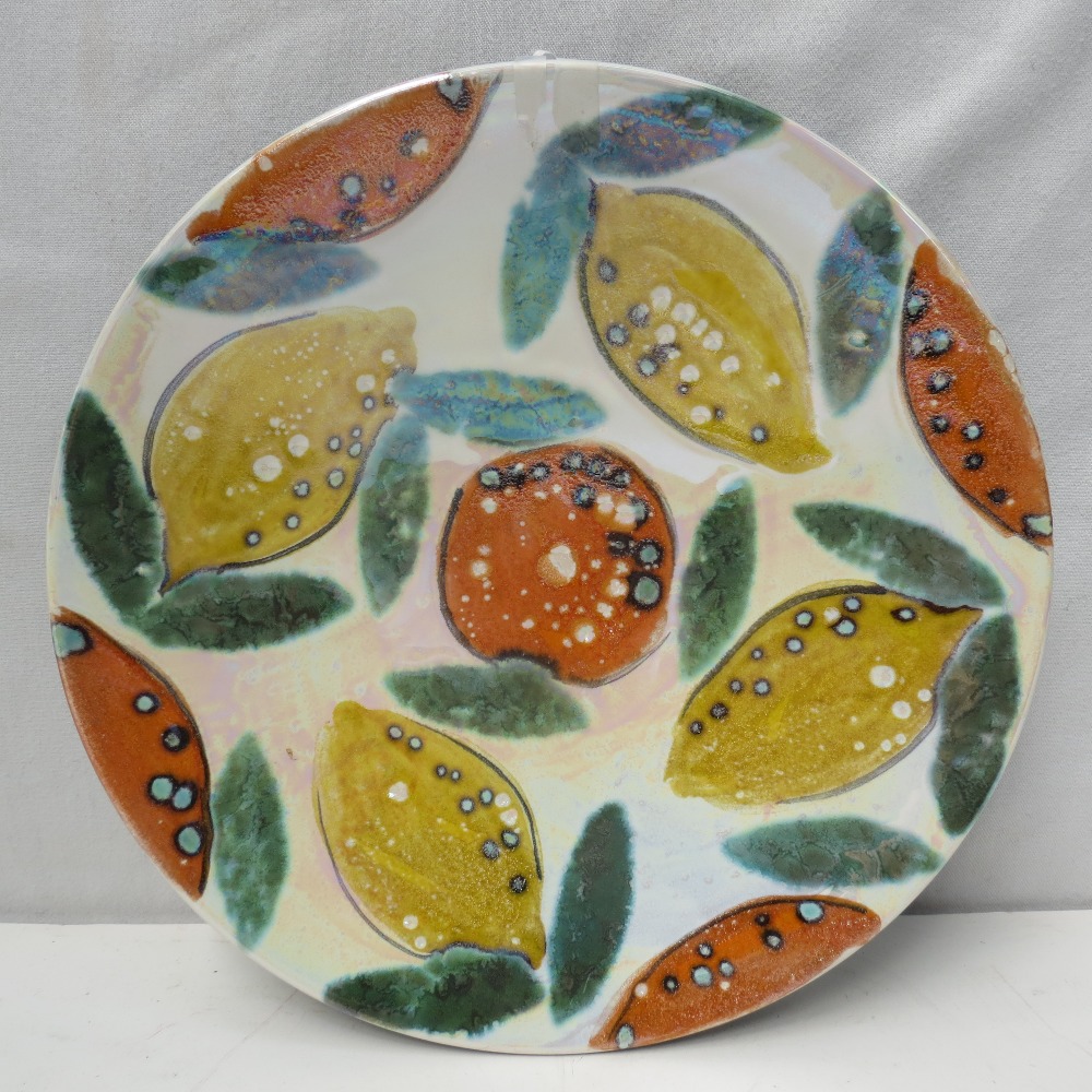 An Anita Harris studio pottery charger decorated with Oranges and Lemons, 24cm