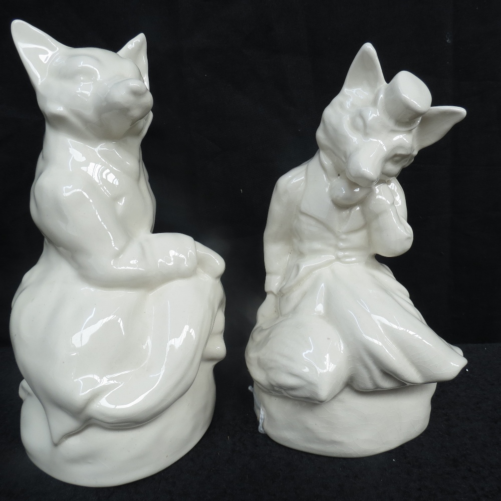 A pair of Staffordshire pottery figures, Mr & Mrs Fox, 21cm