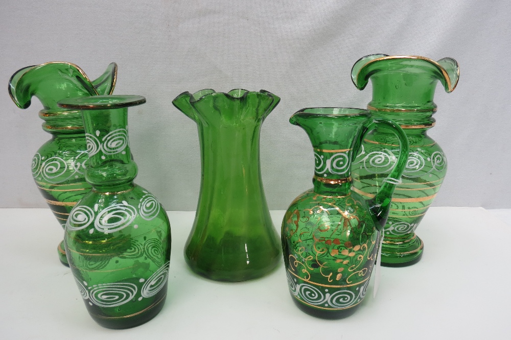 A collection of five hand painted and gilded green glass items