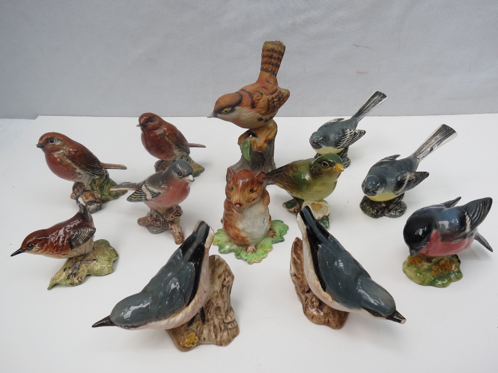 A quantity of Beswick bird figurines (ten) also John Town Mouse by Beswick and an Oriental figure