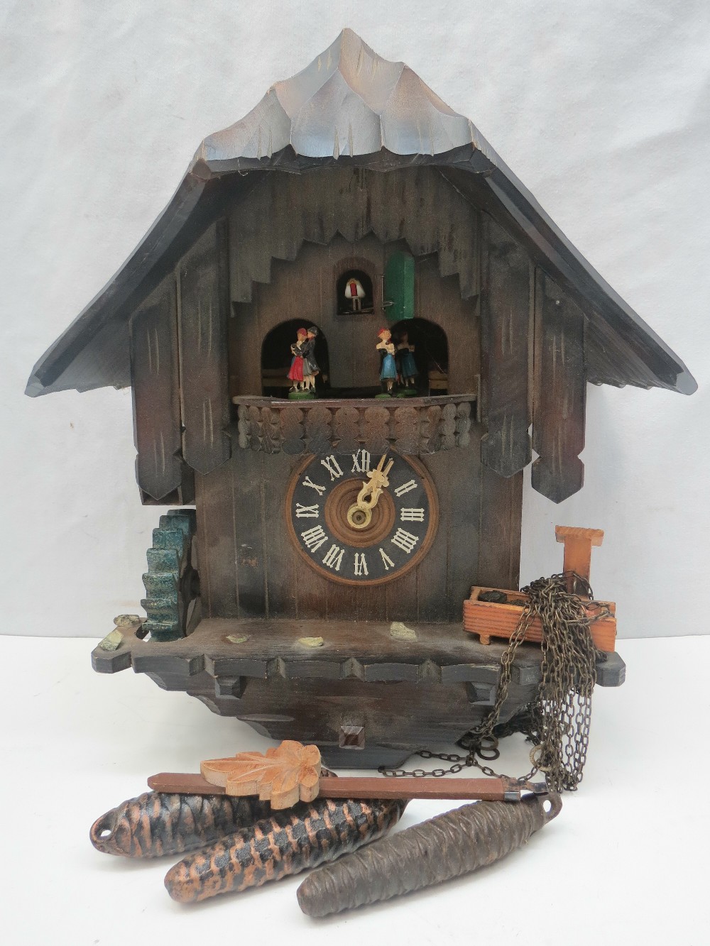 A Post-war, West German made, cuckoo clock, with dancing couples below the cuckoo movement and water