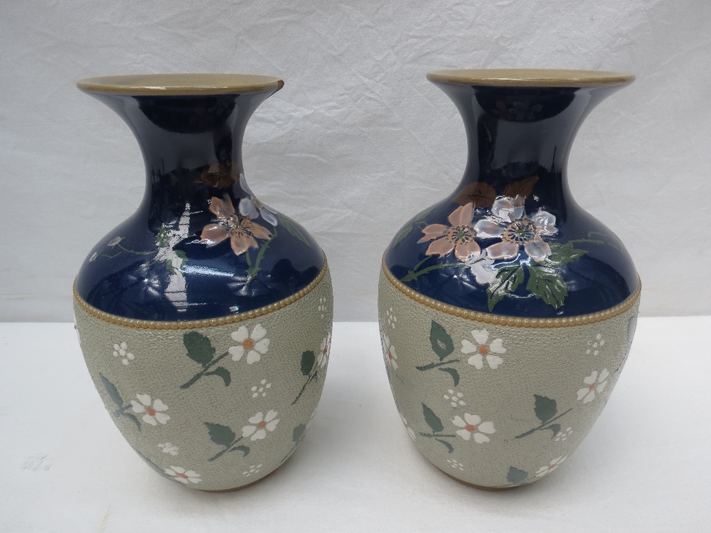 A pair of mantel vases by Lovatt of Langley, Derbys, in the manner of Doulton, with flowers on
