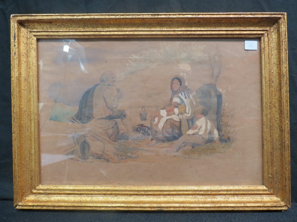 English School (circa 1850) A poor family resting around a camp fire, watercolour; sight size 26cm x