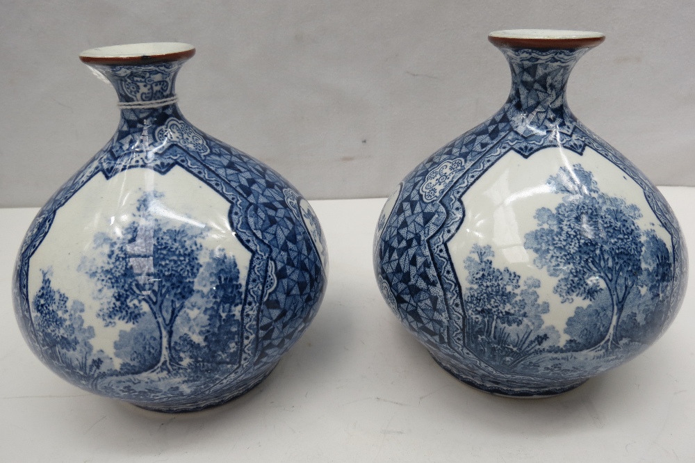 A pair of Royal Bonn blue and white vases in the Flamand design with panel decoration, 13cm.