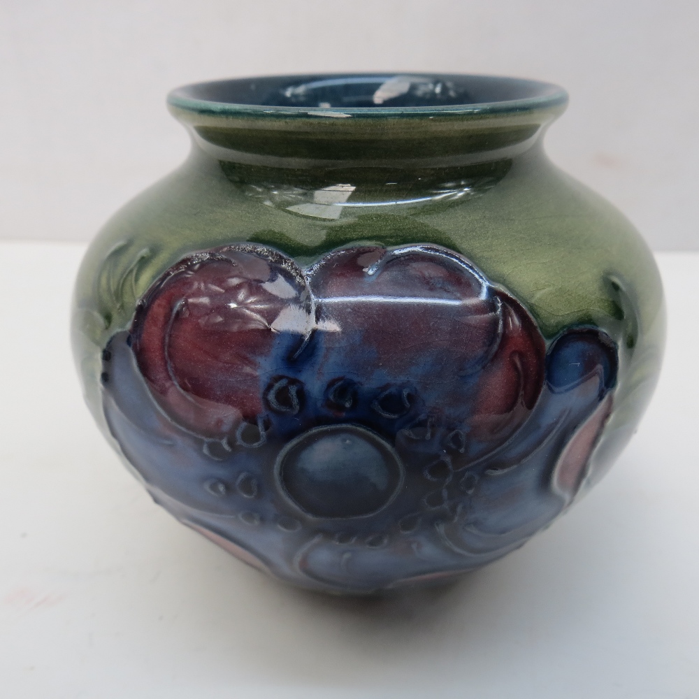 A Moorcroft anemone vase in green with blue interior, impressed Moorcroft mark beneath.