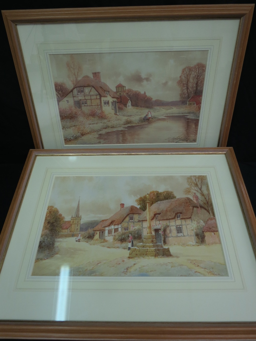 A pair of charming village scenes with figures. Early 20thC watercolours, signed lower right. 26.5 x