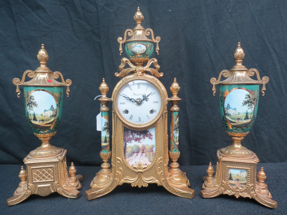 A good quality reproduction ornate French ormolu three piece clock garniture, 42cm.