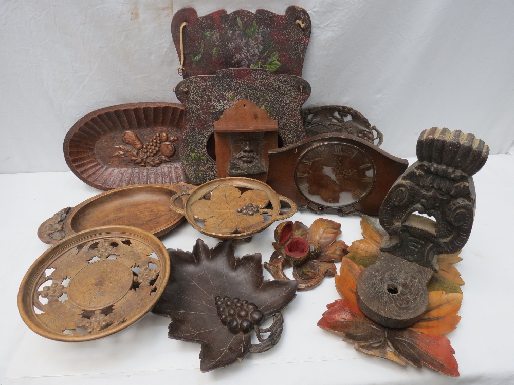 A collection of carved leaf plates and dishes in various woods (eight); two wooden brackets, a hand