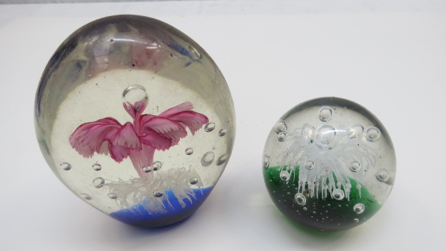 A 20thC glass paperweight cast with a pink flower and white fronds from a blue base, 12cm high and