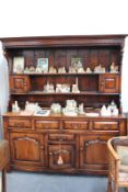 A GOOD QUALITY BESPOKE 17TH.C.STYLE OAK DRESSER WITH CANOPY RACK