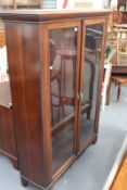 AN EDWARDIAN MAHOGANY GLAZED BOOKCASE