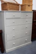 AN IMPRESSIVELY LARGE VICTORIAN PAINTED PINE CHEST OF DRAWERS