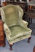 A GEORGIAN STYLE WING BACK ARMCHAIR