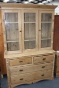 A LARGE VICTORIAN PINE GLAZED TOP CABINET ON CHEST