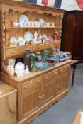 A LARGE PINE KITCHEN DRESSER WITH RACK