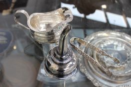 THREE 19TH CENTURY SILVER ITEMS TO INCLUDE A WINE FUNNEL, CREAMER AND A PAIR OF TONGS