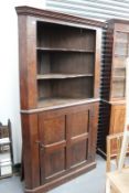 A LARGE SOLID OAK FLOOR STANDING CORNER CABINET