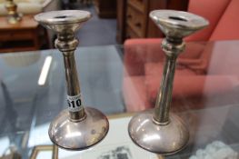 A PAIR OF ARTS AND CRAFTS HALLMARKED SILVER CANDLESTICKS