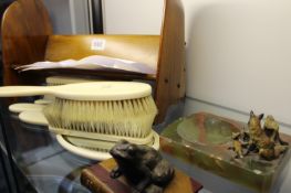 A SMALL BOOKSHELF MADE FROM PROPELLER TIPS, A DRESSING TABLE SET AND TWO ANIMAL FORM PAPER WEIGHTS