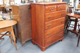 A CHERRY WOOD CHEST OF DRAWERS
